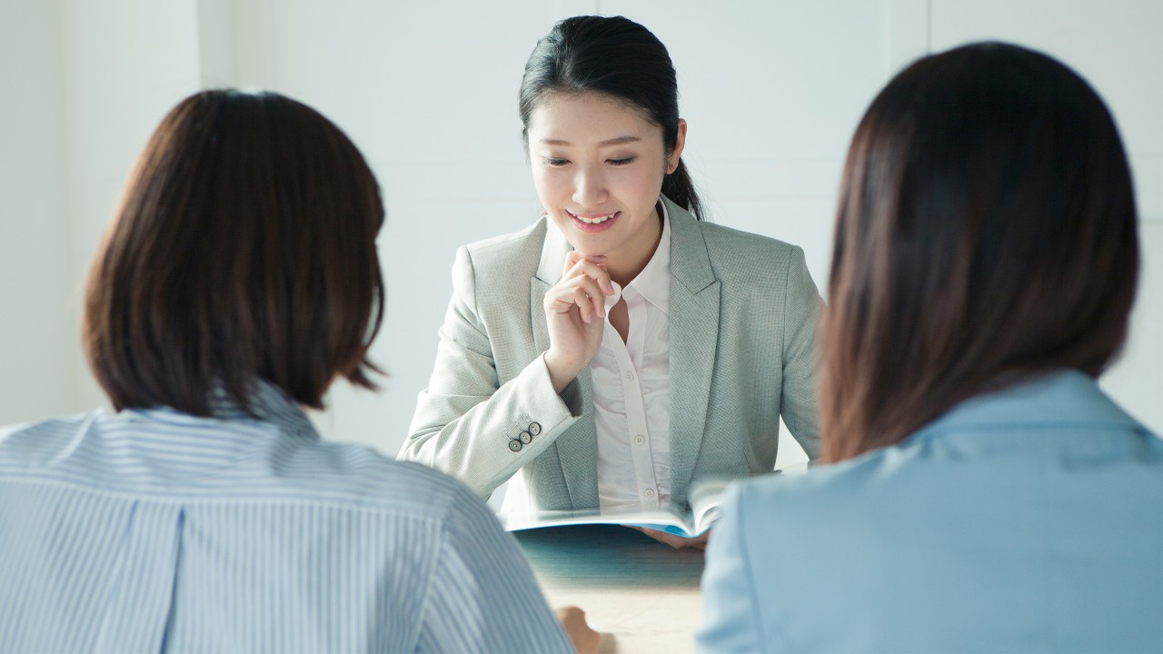 A businesswoman is have a meeting with her colleagues;image used for HSBC branch banking.