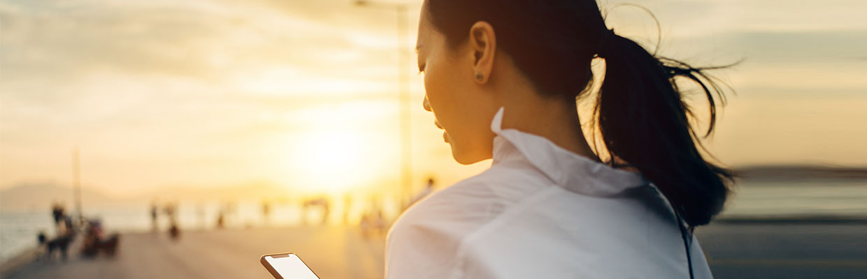 A lady is watching a smartphone; image used for HSBC Online security. 