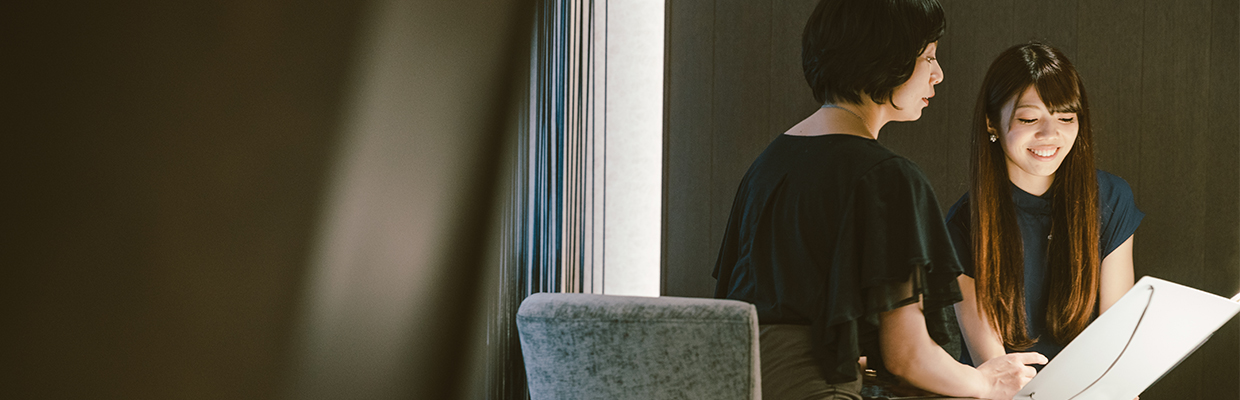 A woman is reviewing her financial portfolio with her financial advisor; image used for unit trust.