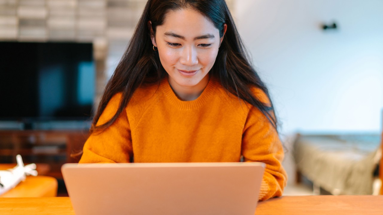 A woman is using laptop; image used for HSBC online banking.